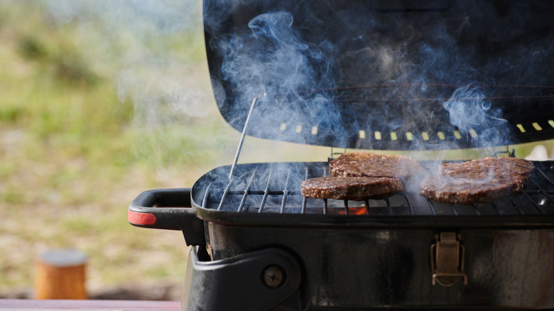 Meat on grill with smoke