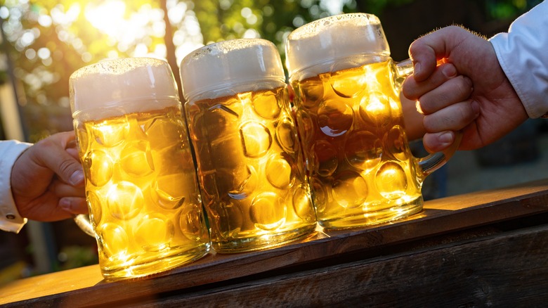 Three beer mugs in sunshine